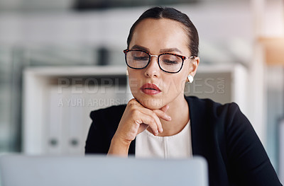 Buy stock photo Cropped shot of an attractive young businesswoman working on a laptop inside her office