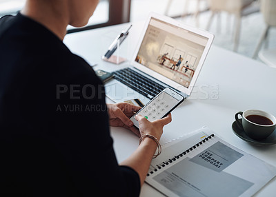 Buy stock photo Cropped shot of an unrecognizable businesswoman using a cellphone while working inside her office