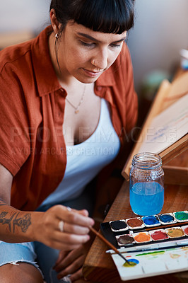 Buy stock photo Cropped shot of an unrecognizable woman working on a painting at home