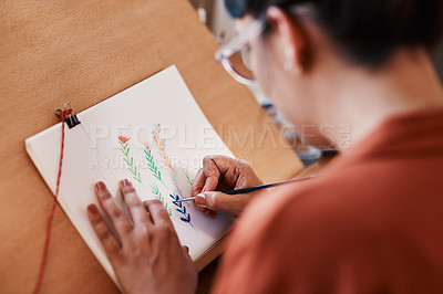 Buy stock photo Cropped shot of an unrecognizable woman working on a painting at home