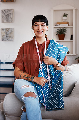 Buy stock photo Shot of a clothes maker posing with fabric at home