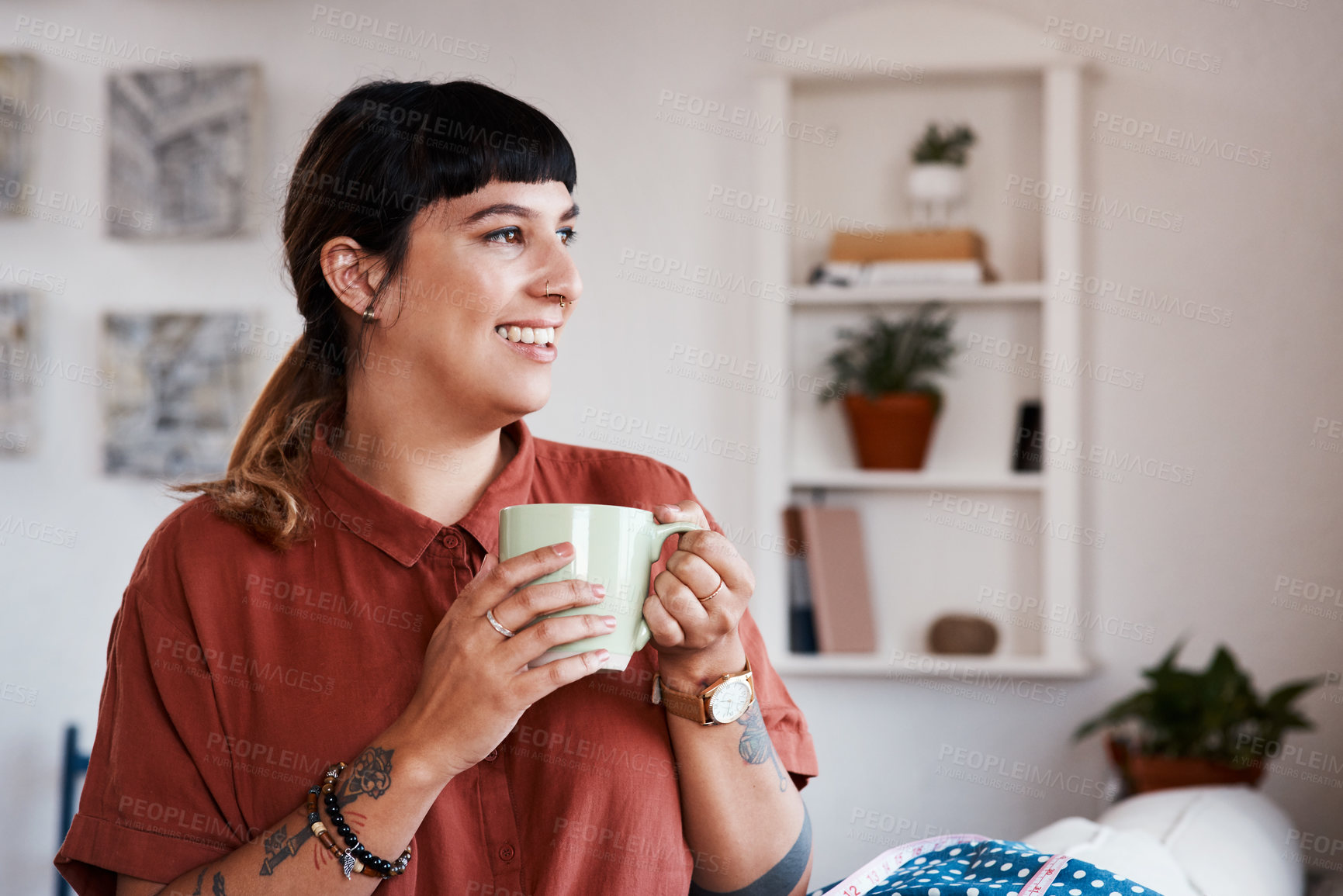 Buy stock photo Shot of a young woman enjoying a cup of coffee while relaxing at home