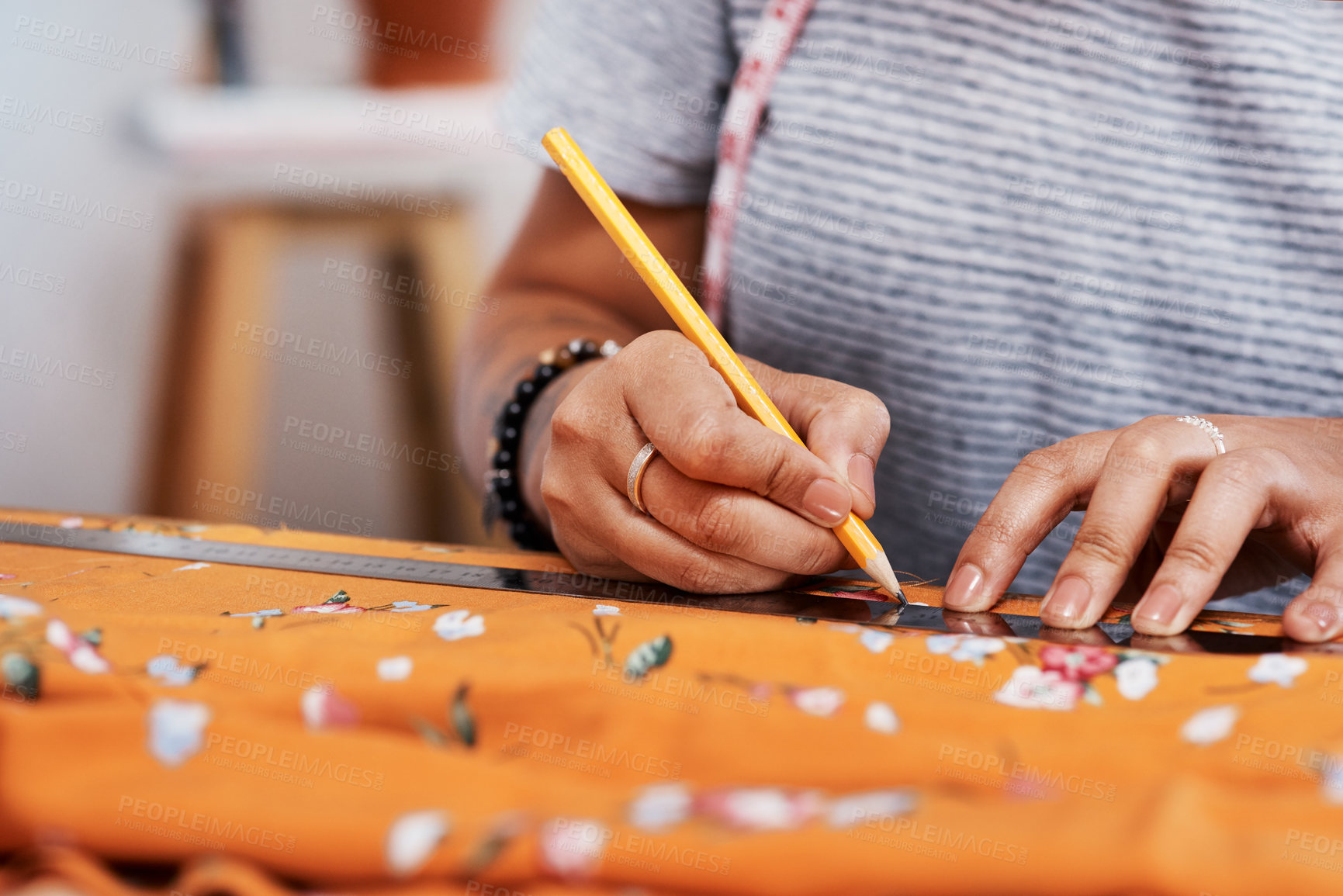 Buy stock photo Cropped shot of a young woman designing a garment at home