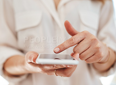 Buy stock photo Cropped shot of an unrecognizable businesswoman using her smartphone inside of an office