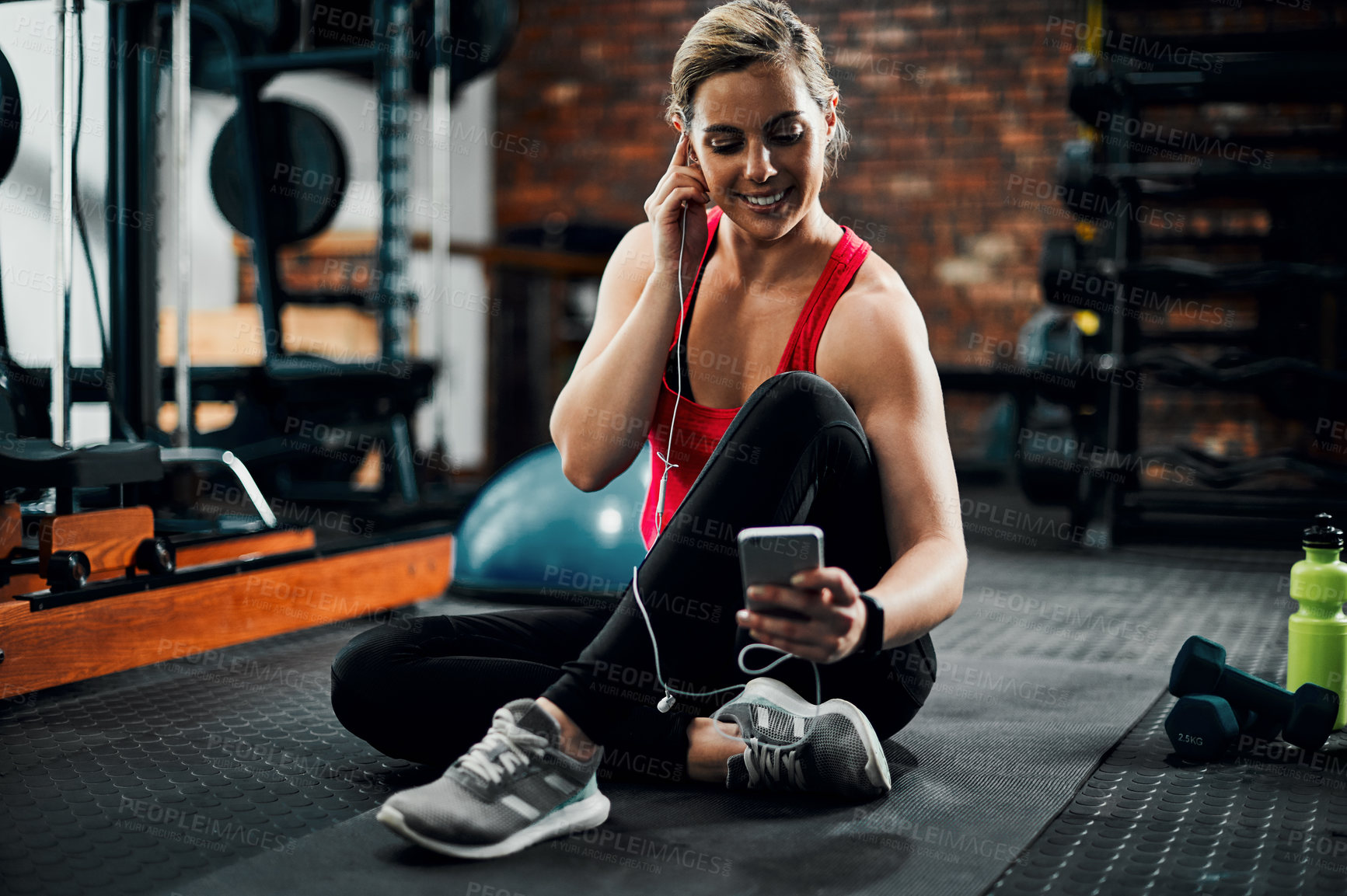 Buy stock photo Gym, woman and music with cellphone for workout, training or exercise with technology. Fitness club, female person and earphones for listening to radio, podcast or scroll on mobile app for playlist