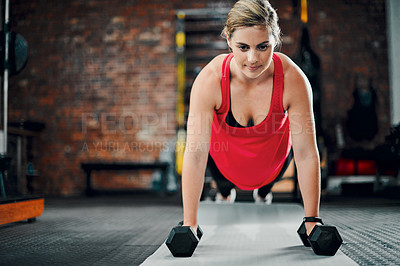 Buy stock photo Full length shot of an attractive young female athlete working out with dumbbells in the gym