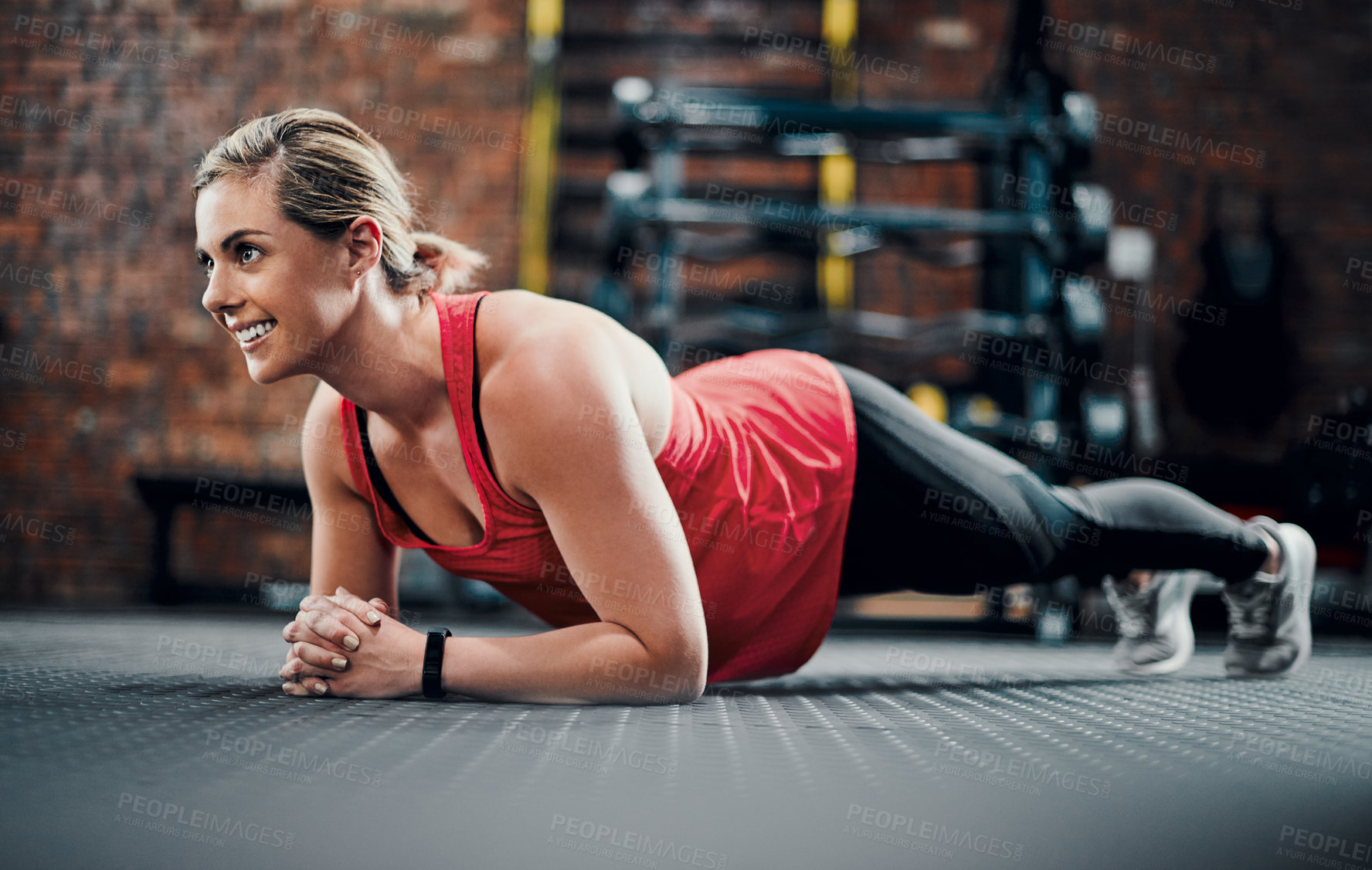 Buy stock photo Full length shot of an attractive young female athlete planking in the gym