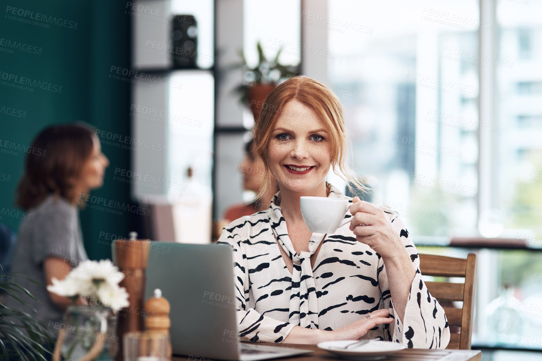 Buy stock photo Portrait of an attractive middle aged woman having a cup of coffee inside of a coffee shop during the day
