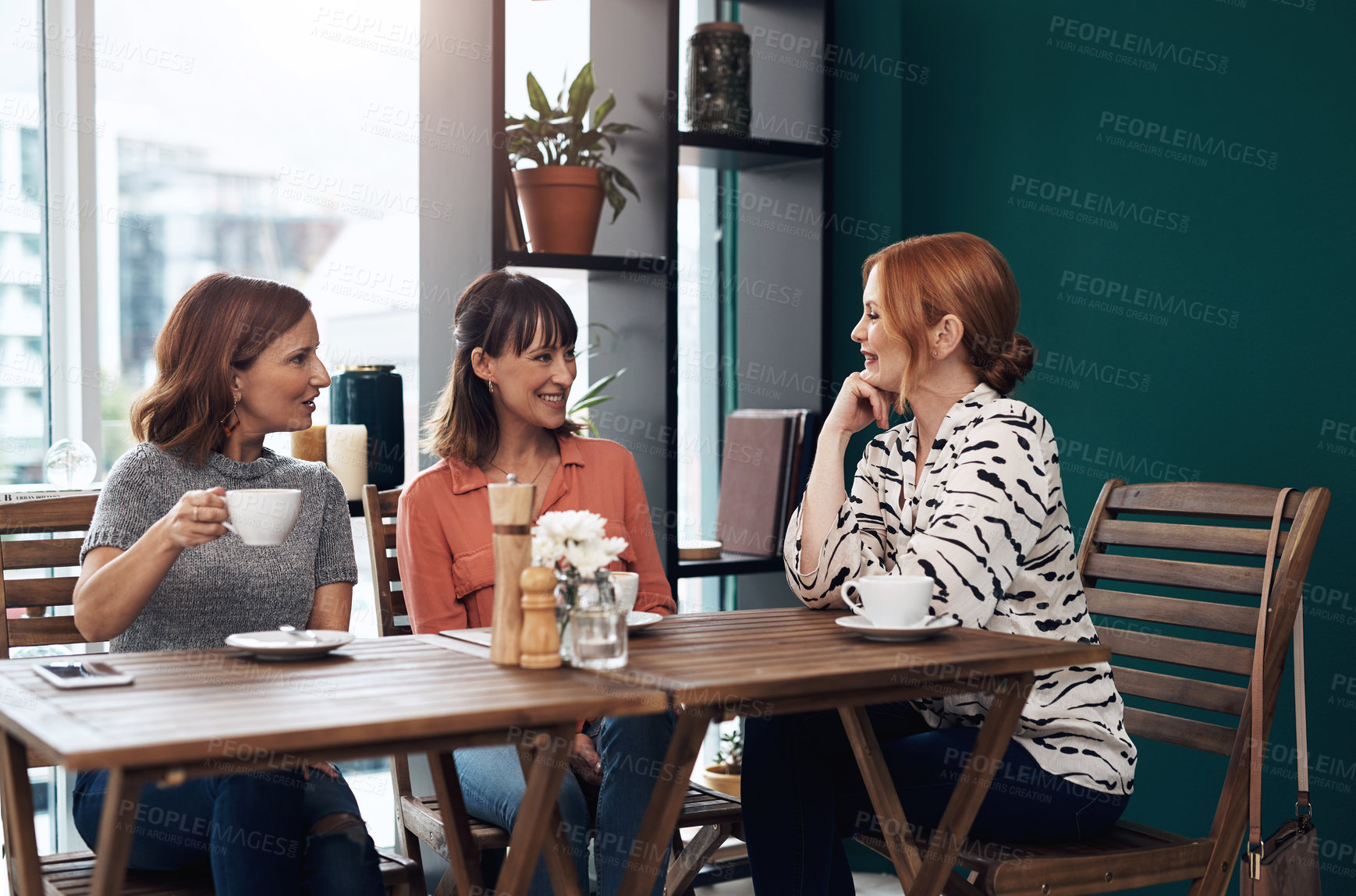 Buy stock photo Cropped shot of a group of attractive middle aged women having a coffee date together as friends inside of a coffee shop during the day