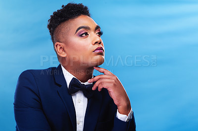 Buy stock photo Cropped shot of a gender fluid young businessman posing against a blue background