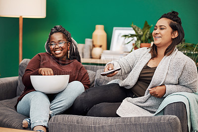 Buy stock photo Girl friends, watching tv and home living room laughing on a couch with a happy smile. Series, funny movie and women together in a lounge with a friend looking at a television in house with popcorn