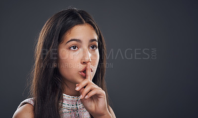 Buy stock photo Girl, whisper and finger for silence in studio, quiet and privacy symbol on gray background. Female person, confidential and mockup space for shush or secret, mystery and emoji for gossip or news