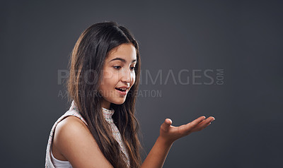 Buy stock photo Cropped shot of an attractive teenage girl standing alone against a dark background in the studio