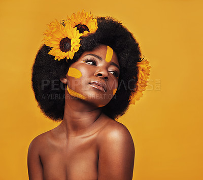 Buy stock photo Black woman, beauty and sunflower with skincare in studio for natural glow, dermatology or soft skin. Person, floral and confident with plant for organic, cosmetics and vitamin e on yellow background
