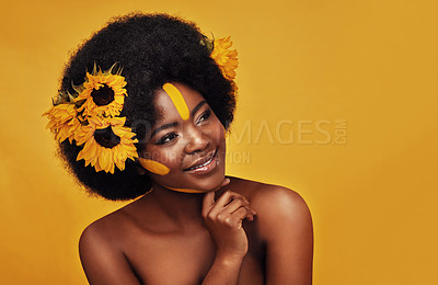 Buy stock photo Black woman, studio and happy with natural sunflowers, nature skincare and rest with African model and afro. Selfcare, wellness for beauty with organic cosmetics, dermatology on yellow background