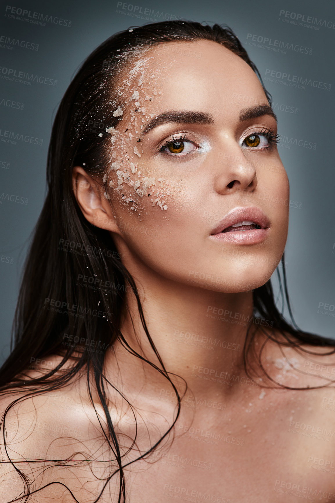 Buy stock photo Portrait, woman and salt in studio for skincare, organic treatment and exfoliation for beauty. Girl, dermatology and scrub on face for skin detox, natural cleansing and aesthetic on dark background