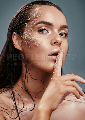 Buy stock photo Shot of a beautiful young woman posing with salt on her face