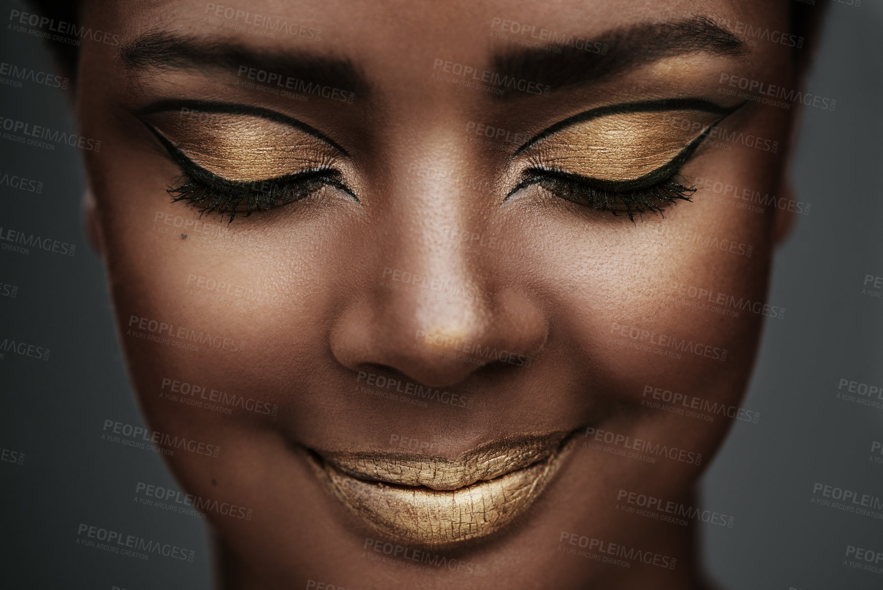 Buy stock photo Cat eye, beauty and happy woman with makeup, creative art and gold eyeshadow on face. African model, facial cosmetics and eyeliner with eyes closed for skin glow on gray studio background closeup