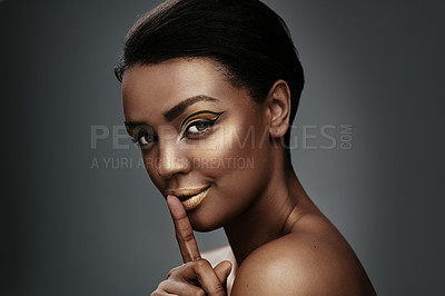 Buy stock photo Black woman, makeup and portrait in studio with hush, smile and confidence with secret. Girl, gold cosmetics and gesture on gray background for privacy, silence and whisper for gossip in Nigeria