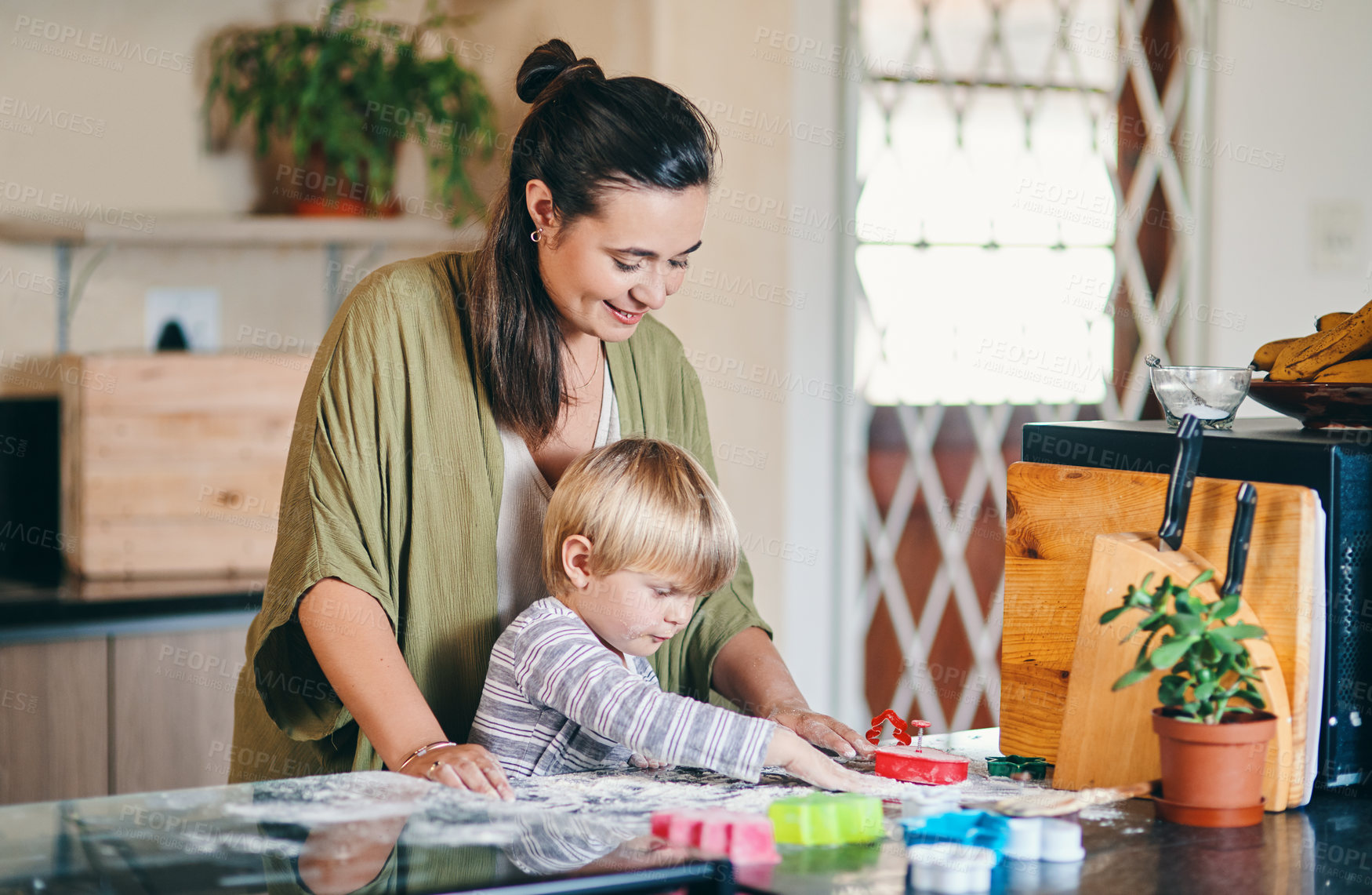 Buy stock photo Shot of an adorable little boy baking with his mother at home