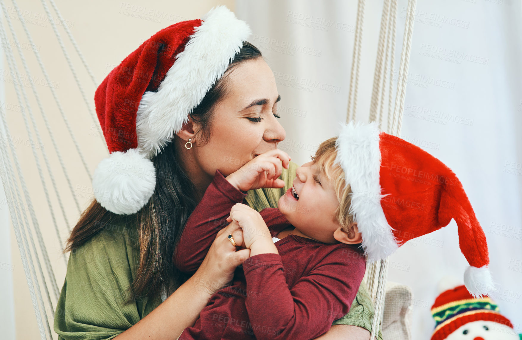 Buy stock photo Shot of a young woman spending quality time with her adorable son at Christmas