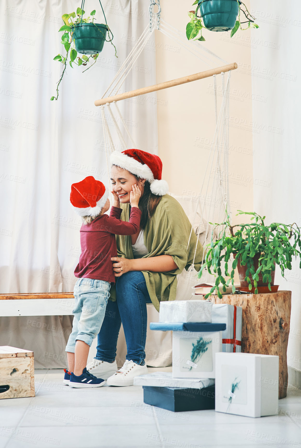 Buy stock photo Shot of a young woman spending quality time with her adorable son at Christmas