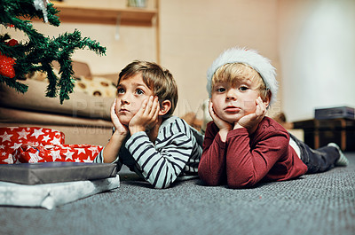 Buy stock photo Christmas, portrait and kids waiting for present to celebrate winter holiday, vacation or gift in home. Children siblings, confident or young brothers lying on carpet to relax for xmas festive season