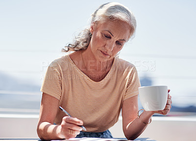 Buy stock photo Writing, book and an elderly woman author sitting outdoor in summer for inspiration as a writer. Idea, planning and a female pensioner drinking coffee while using a pen to write in a journal outside