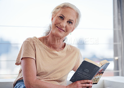 Buy stock photo Cropped portrait of an attractive senior woman reading a book while relaxing on her balcony at home