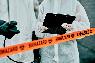 Buy stock photo Covid, pandemic and team doctors, scientists or healthcare workers wearing protective ppe to prevent virus spread at quarantine site. First responders wearing hazmat suit while standing behind tape 