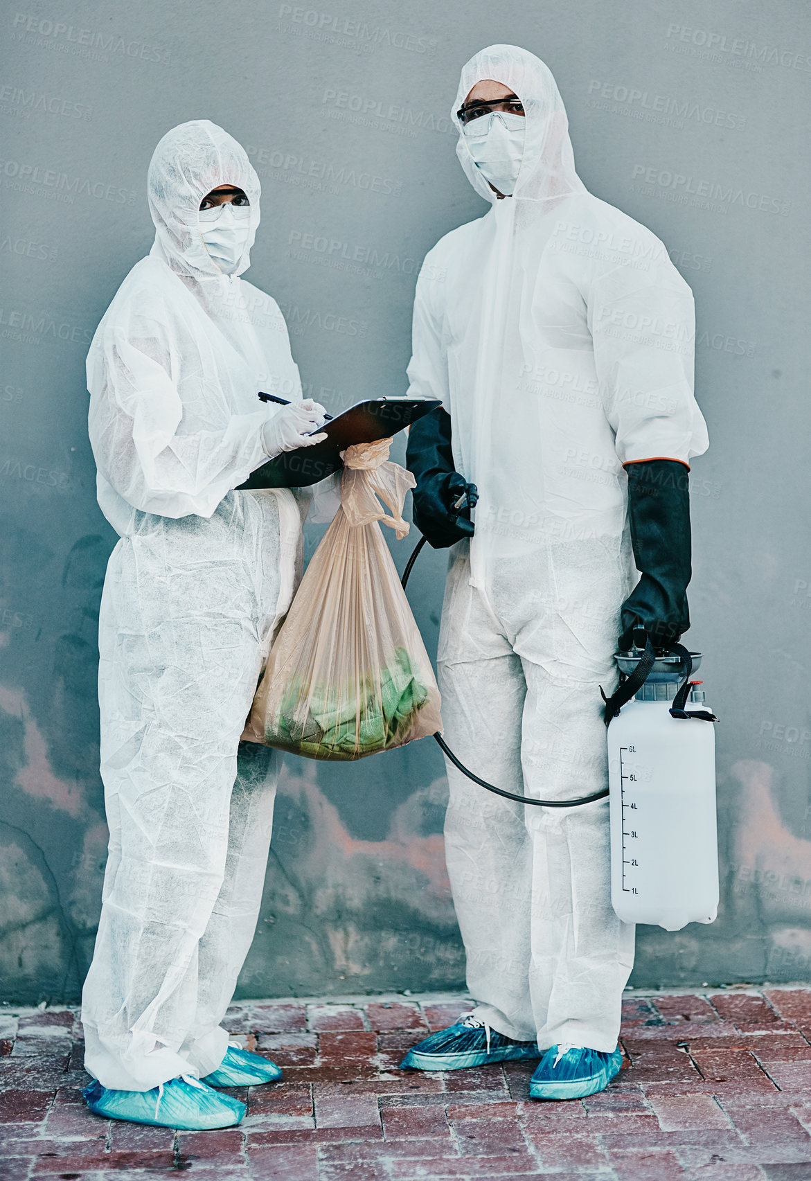 Buy stock photo Scientists disinfect isolated and dangerous area. Medical staff protect themselves with sterile equipment. Healthcare workers clean while wearing safety uniform to stop the spread of a virus.