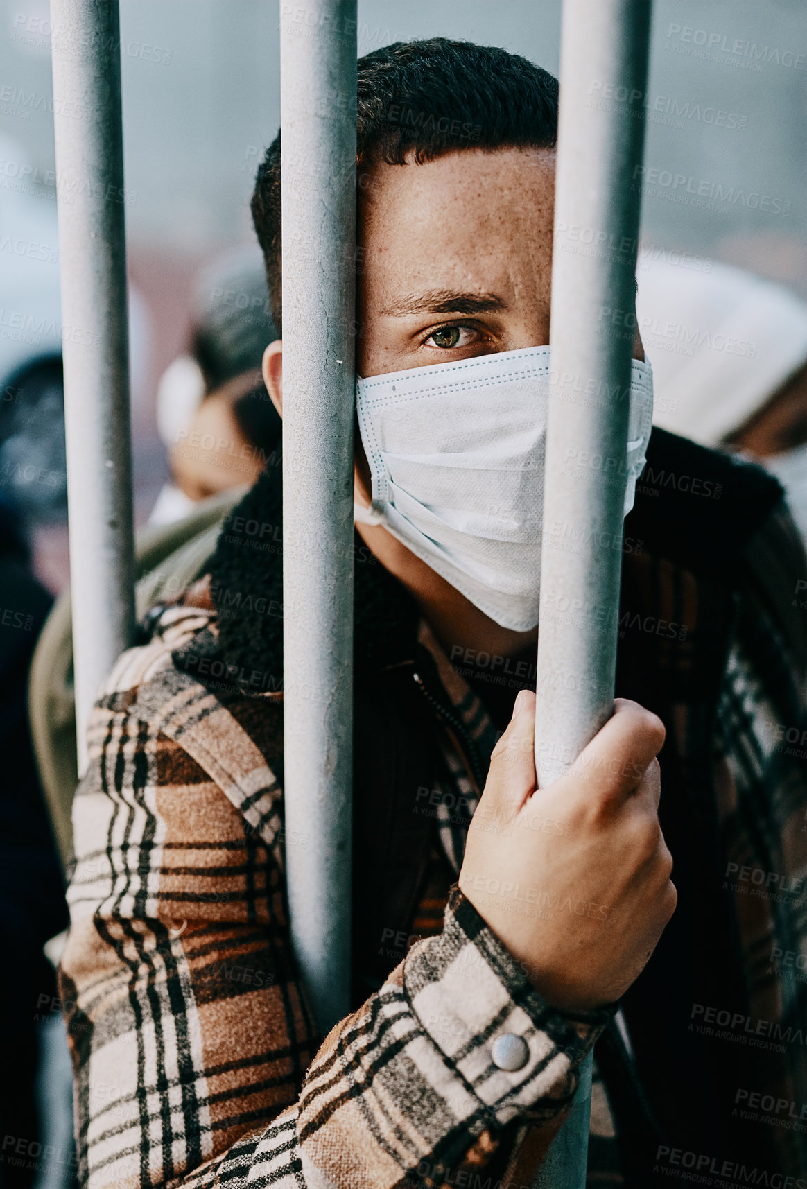 Buy stock photo Sick, refugee of a young covid patient in quarantine to cross the border with a medical face mask. Foreign man in a prison crowd during a pandemic following healthcare safety rules of the virus.