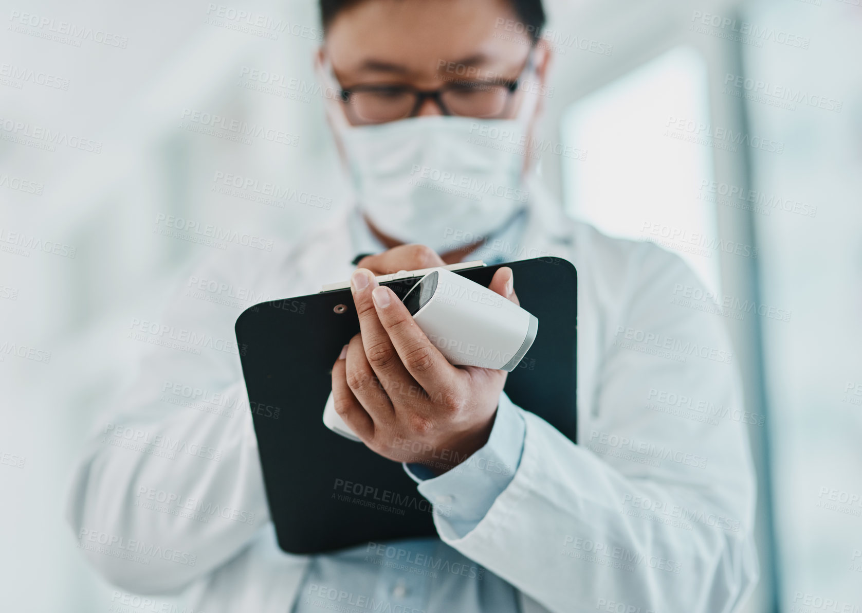 Buy stock photo Covid, pandemic and virus, doctor or medical healthcare worker writing on a clipboard. Scientist wearing a mask to prevent the spread of the sickness and keep a checklist of infected patients 