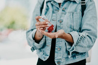 Buy stock photo Closeup of woman using hand sanitizer while in public or travelling with copy space. Female practicing good health and hygiene, sticking to corona regulations. Lady suffering from OCD or germ phobia