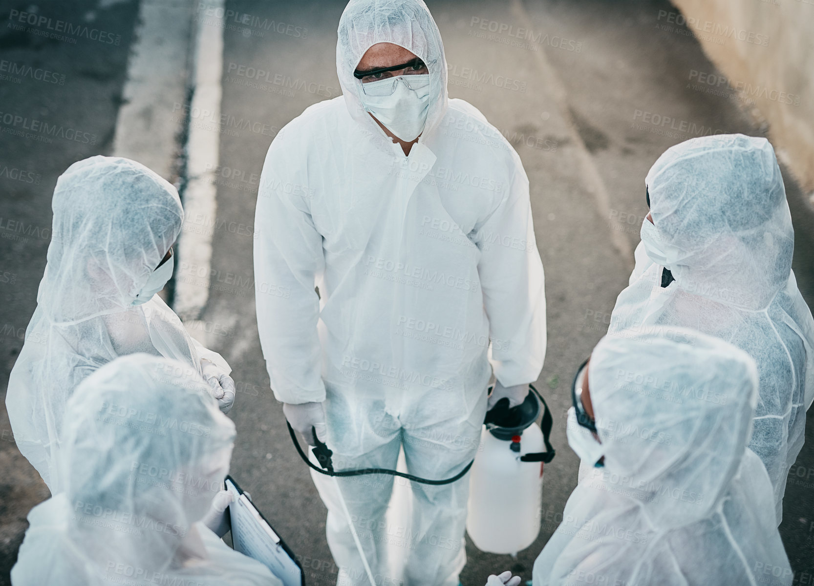 Buy stock photo Covid pandemic outbreak team of doctors or medical workers wearing protective ppe to prevent spread of virus outside. Group of scientists wearing hazmat suit for corona or ebola disease in the street