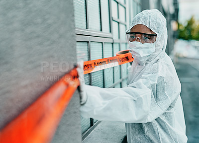 Buy stock photo Covid healthcare worker responding to a biohazard in a public area using barrier tape outside. First responder in protection hazmat suit and mask separating a space due to a new pandemic or outbreak 