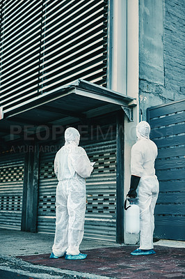 Buy stock photo Medical team and covid hygiene healthcare workers wearing hazmat suits for safety while at quarantine site outside. In protective gear for cleaning, disinfection and decontamination to fight virus