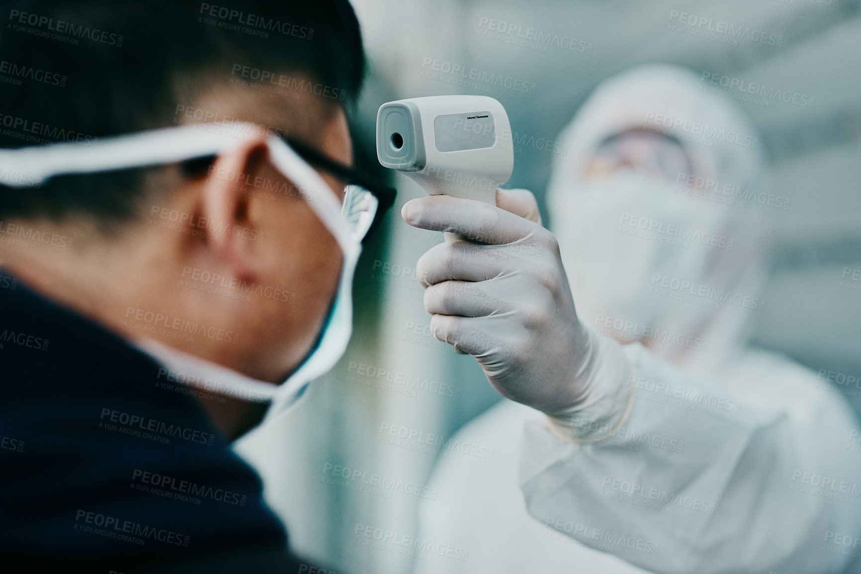 Buy stock photo Travel, healthcare and covid temperature testing outside with an infrared thermometer. Medical professional doing a coronavirus check on a man at airport entrance to prevent the spread of the virus
