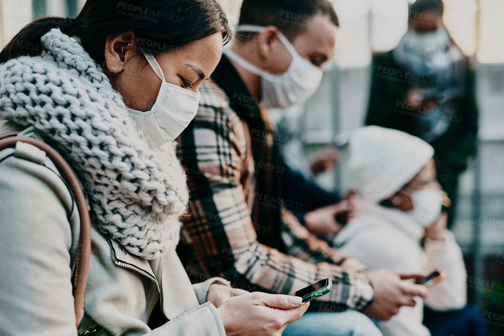 Buy stock photo Shot of a young woman using a smartphone and wearing a mask while travelling in a foreign city