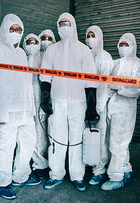 Buy stock photo Shot of a group of healthcare workers wearing hazmat suits working together to control an outbreak