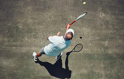 Buy stock photo High angle shot of a focused middle aged man playing tennis outside on a tennis court during the day