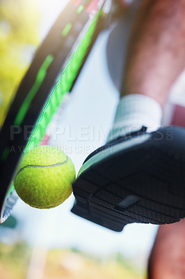 Buy stock photo Cropped shot of an unrecognizable tennis player kicking a tennis ball against a racket on a tennis court outdoors