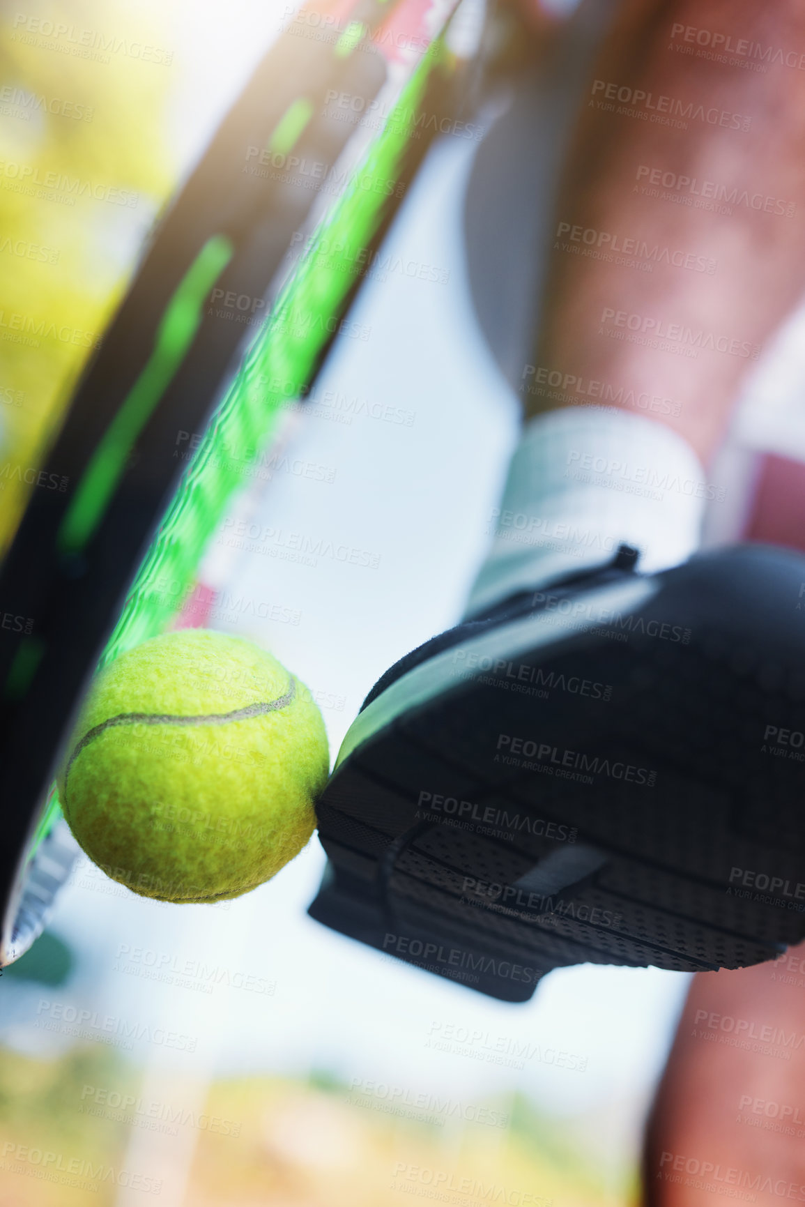 Buy stock photo Cropped shot of an unrecognizable tennis player kicking a tennis ball against a racket on a tennis court outdoors