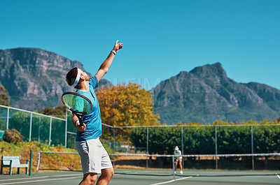 Buy stock photo Cropped shot of a young male tennis player getting ready to serve the ball on a tennis court outdoors