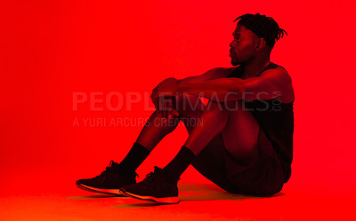 Buy stock photo Red filtered shot of a young sportsman posing in the studio