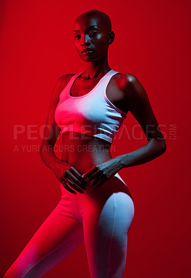 Buy stock photo Red filtered shot of a sporty young posing in the studio