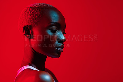 Buy stock photo Red filtered shot of a beautiful young woman posing in the studio