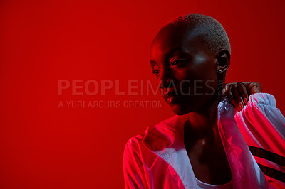 Buy stock photo Red filtered shot of a sporty young posing in the studio