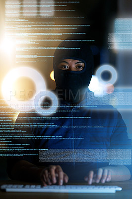 Buy stock photo Shot of a hacker cracking a computer code in the dark