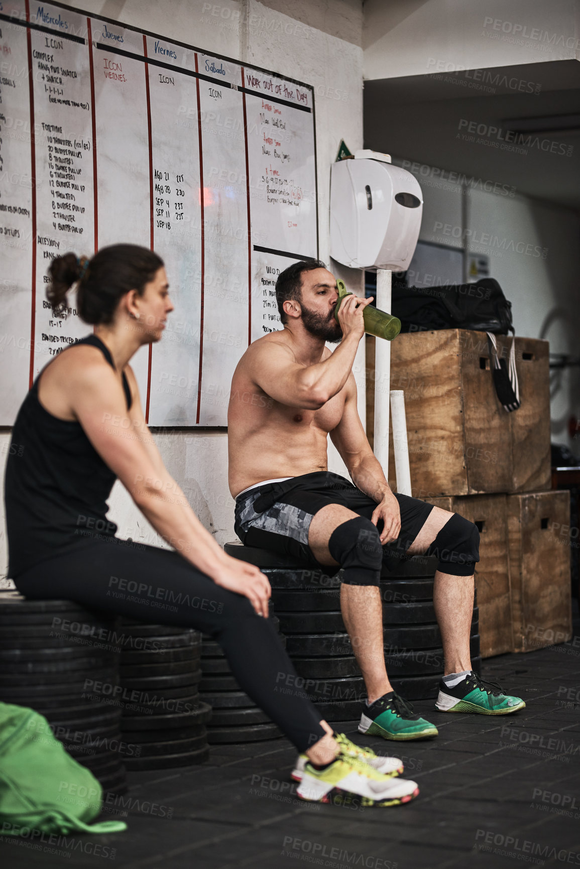 Buy stock photo Shot of people taking a break from a workout in a gym